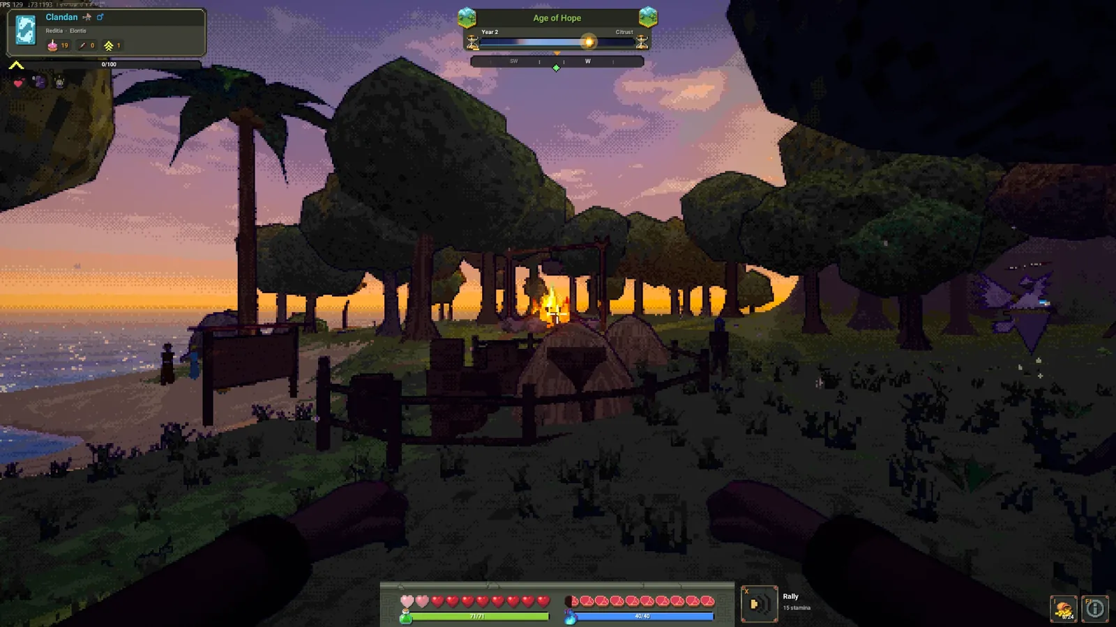 The same camp at sunset, the sky orange behind the trees and the sea glittering.